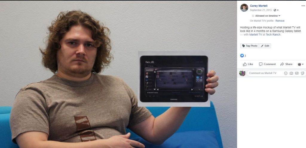 A photo of myself from 2013, posing with a mockup of what I envisioned my video streaming platform interface to look like.