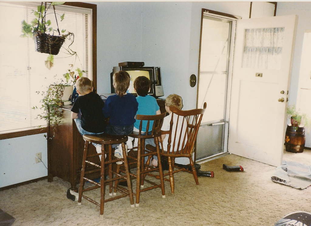 Playing Nintendo in the living room of the old house with other kids.